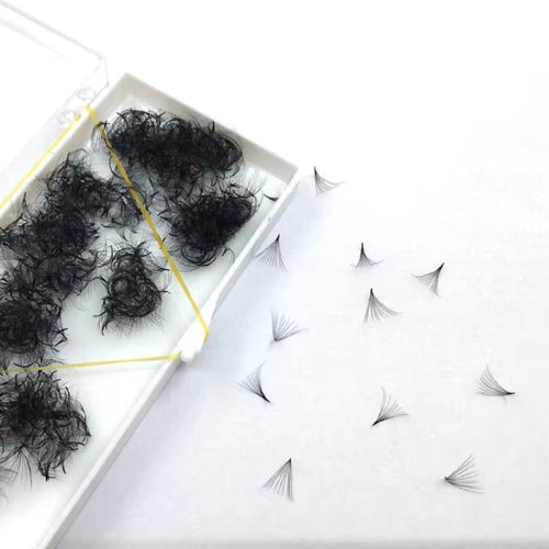Black hair extensions in a box on a white background