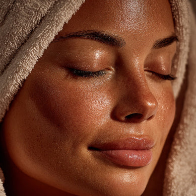 Close-up of a person with a towel wrapped around their head, focusing on the skin texture.